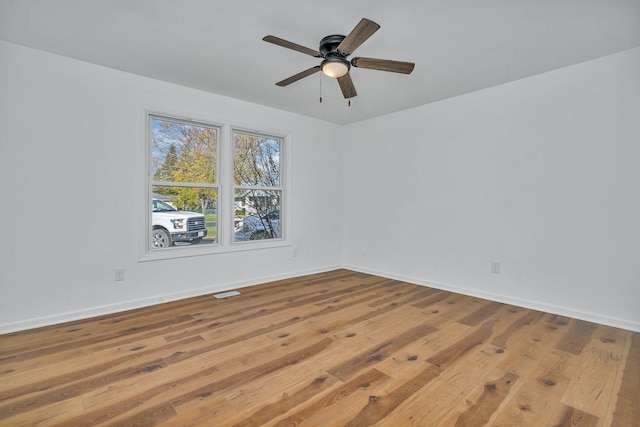 spare room with light hardwood / wood-style floors and ceiling fan