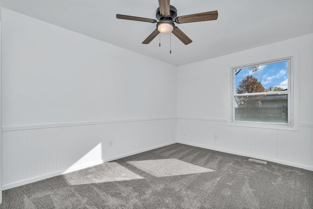 carpeted spare room with ceiling fan