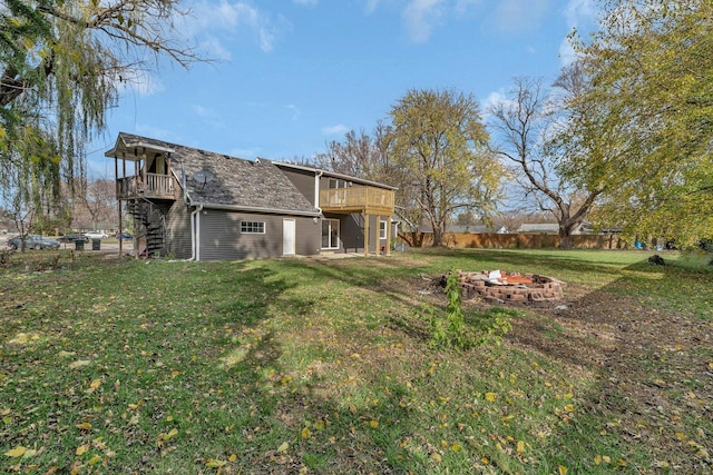 view of yard featuring an outdoor fire pit and a wooden deck