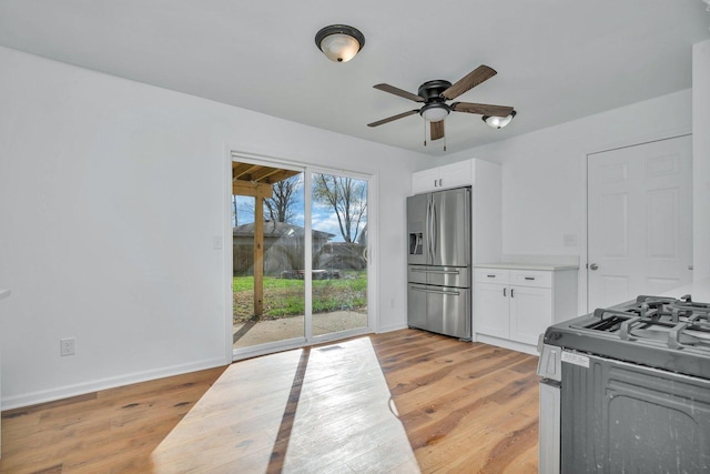 kitchen with white cabinetry, ceiling fan, light hardwood / wood-style floors, and appliances with stainless steel finishes