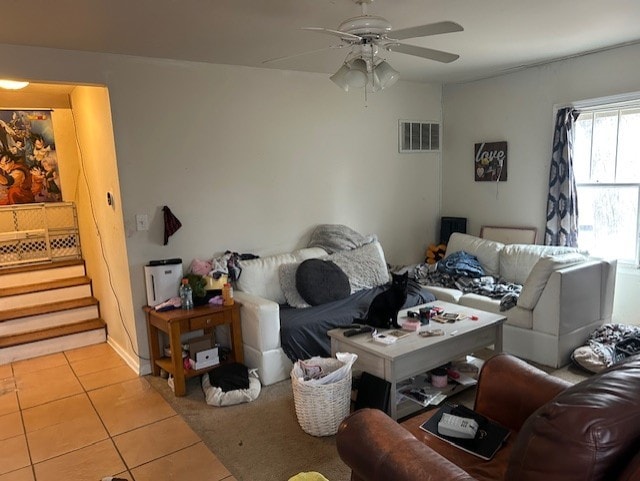 living room with ceiling fan and light tile patterned floors