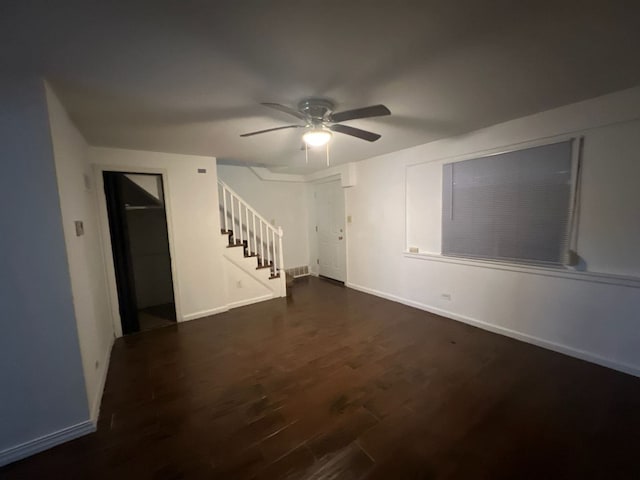 spare room featuring dark hardwood / wood-style flooring and ceiling fan