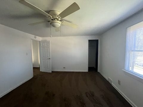 carpeted spare room with plenty of natural light and ceiling fan