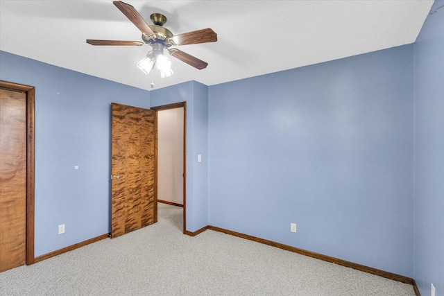 unfurnished bedroom featuring ceiling fan and light carpet