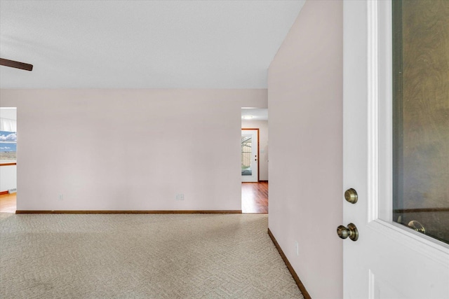 empty room featuring carpet and lofted ceiling