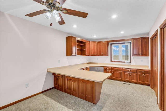 kitchen featuring light carpet, a peninsula, baseboards, light countertops, and open shelves