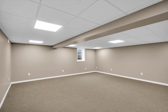 basement with carpet and a drop ceiling