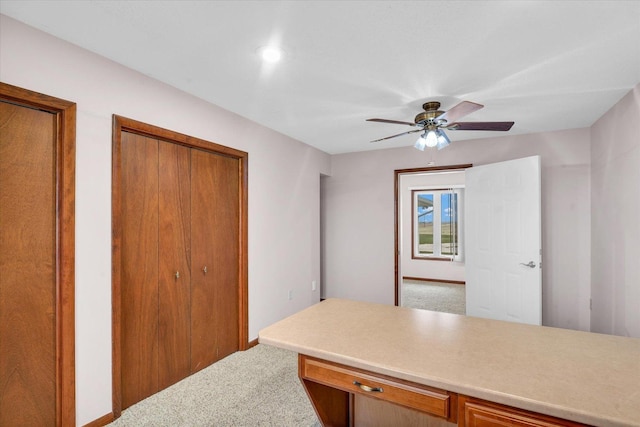 home office with a ceiling fan and carpet flooring