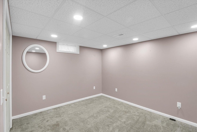 basement with carpet and a drop ceiling