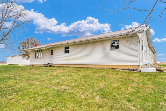 rear view of house with a yard