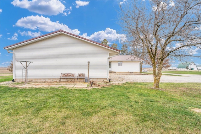 view of property exterior with a yard