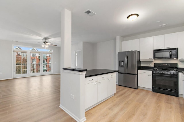 kitchen with white cabinets, light hardwood / wood-style flooring, and black appliances