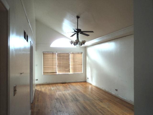 empty room with ceiling fan, wood-type flooring, and lofted ceiling