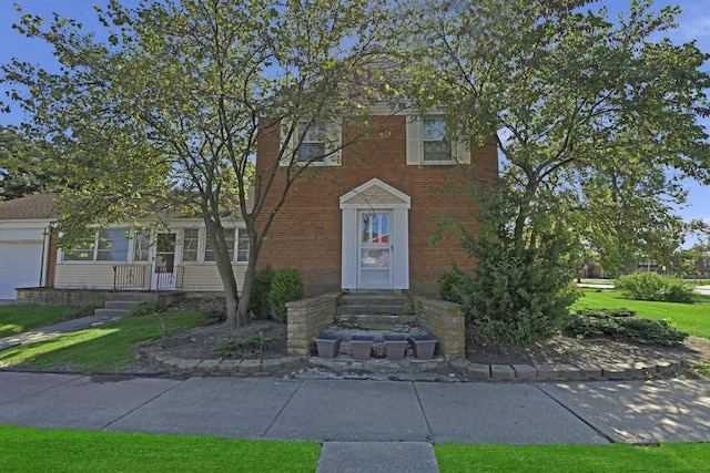 view of front of house featuring a garage and a front lawn