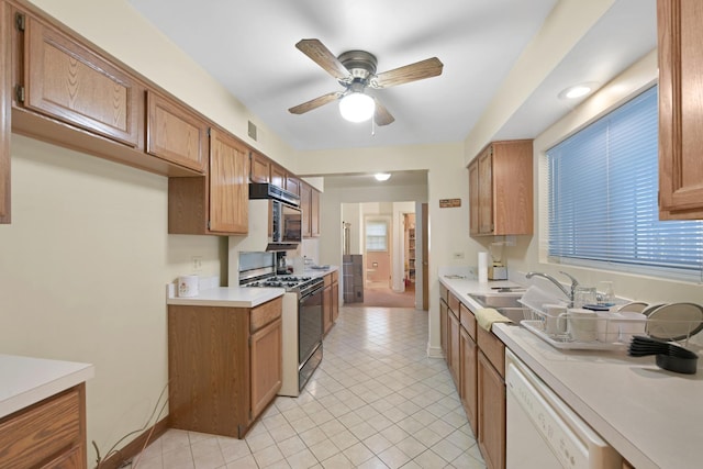 kitchen with ceiling fan, sink, dishwasher, light tile patterned flooring, and range