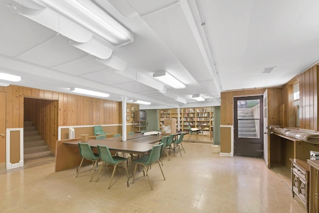 dining room with wood walls