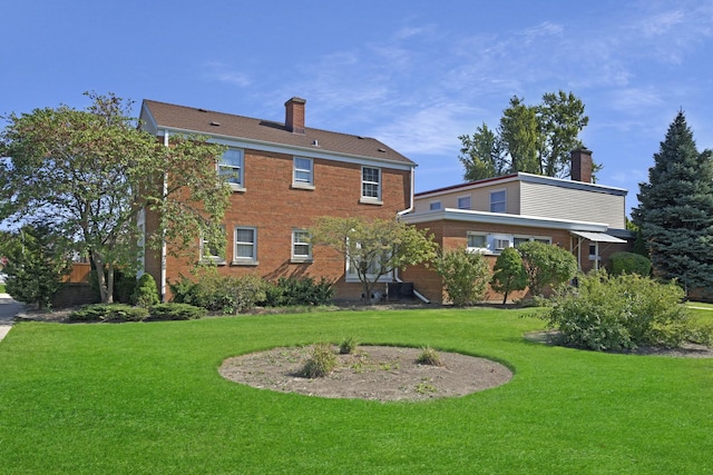 rear view of property with a lawn