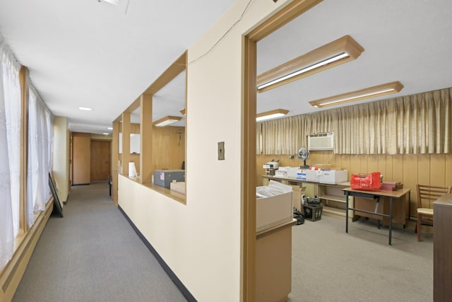 corridor featuring light carpet and wood walls