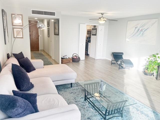 living room with ceiling fan and hardwood / wood-style floors