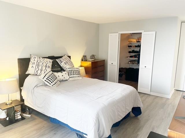 bedroom with a closet and hardwood / wood-style flooring