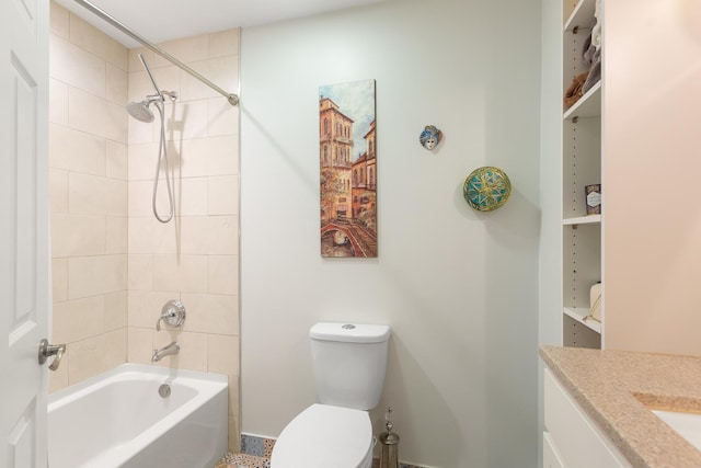 full bathroom featuring vanity, tiled shower / bath combo, and toilet