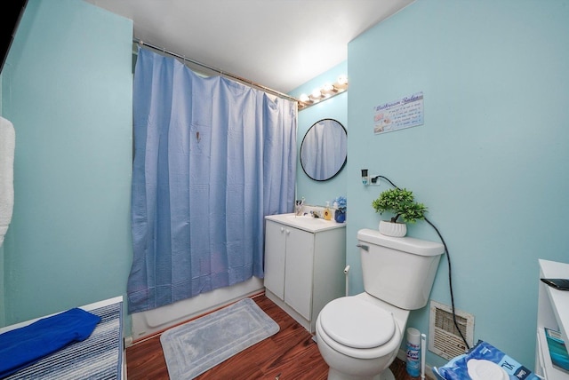 bathroom with a shower with shower curtain, wood-type flooring, vanity, and toilet