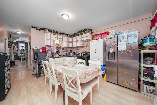 kitchen featuring white cabinetry, stainless steel appliances, and light hardwood / wood-style flooring