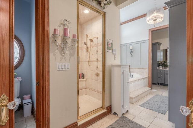 bathroom featuring a chandelier, tile patterned flooring, and independent shower and bath