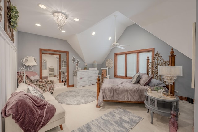 carpeted bedroom with ceiling fan with notable chandelier and vaulted ceiling