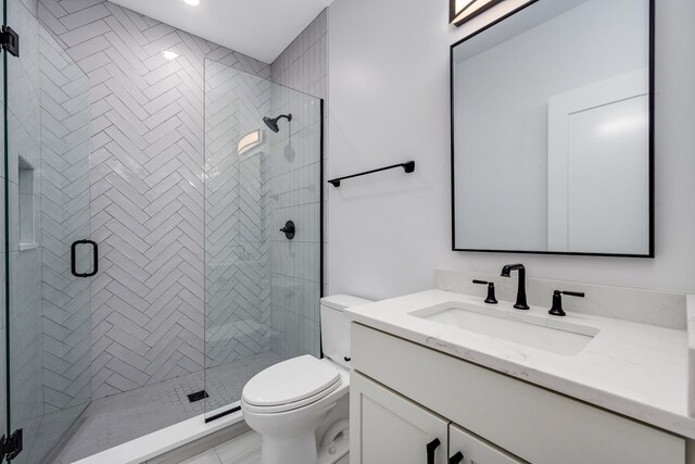 bathroom with vanity, toilet, and a shower stall