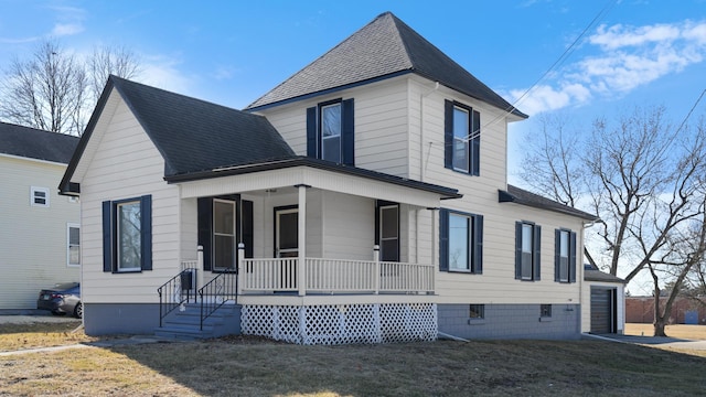 view of front facade featuring covered porch and a shingled roof