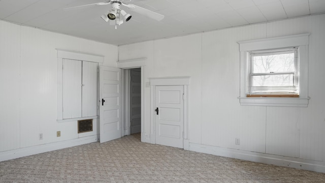 unfurnished bedroom with a ceiling fan and carpet