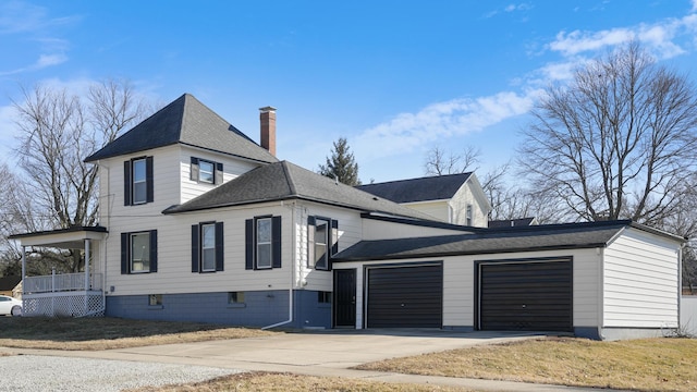 view of front of house featuring a garage, driveway, roof with shingles, a front lawn, and a chimney