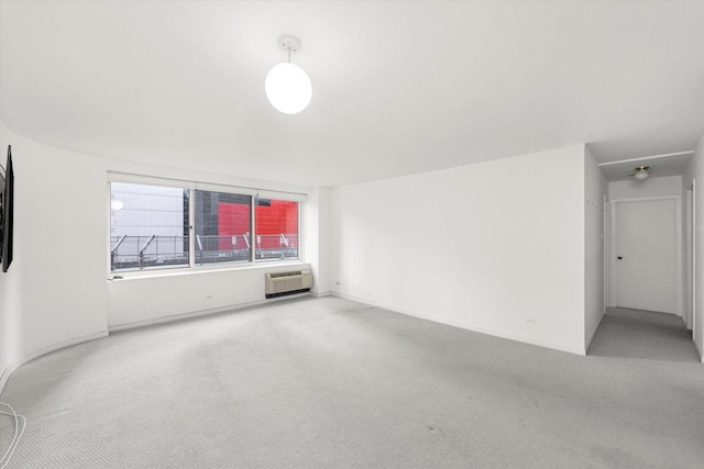 unfurnished living room featuring carpet floors and a wall unit AC