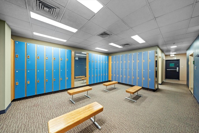 interior space featuring a drop ceiling and carpet