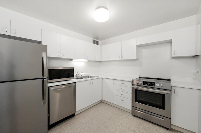 kitchen with white cabinetry, sink, and appliances with stainless steel finishes