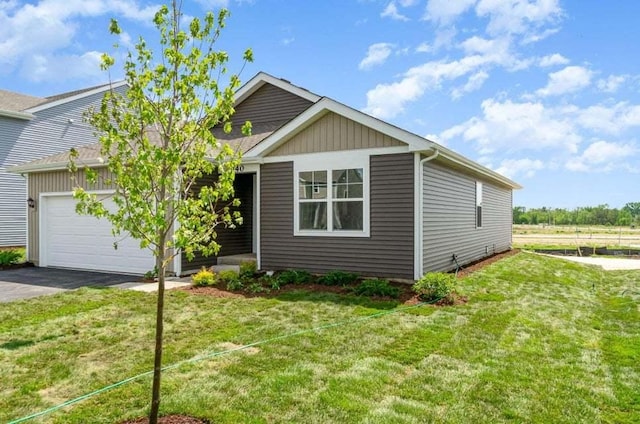 view of front of property with a front yard and a garage