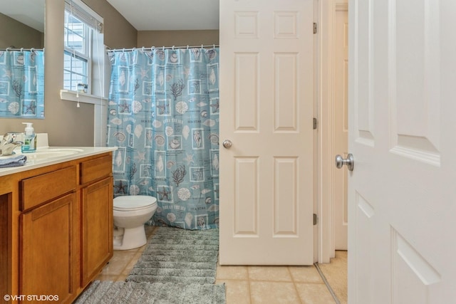 bathroom featuring tile patterned flooring, vanity, and toilet