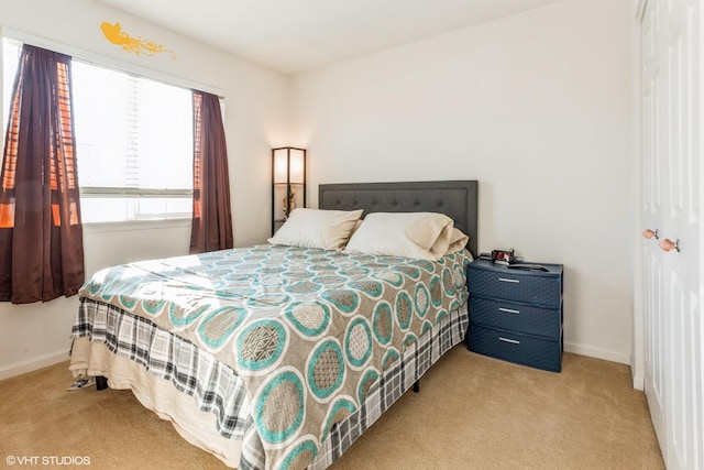 bedroom featuring light colored carpet