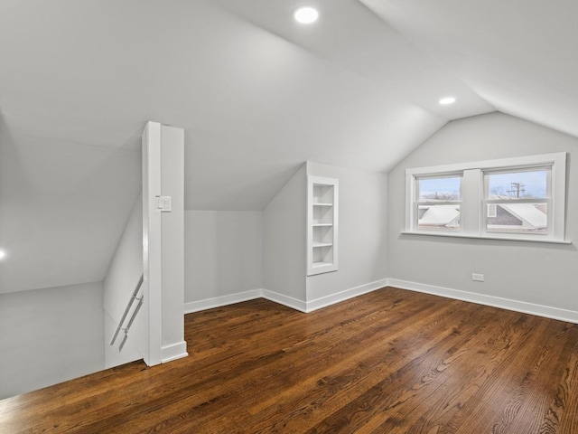 additional living space with lofted ceiling and dark hardwood / wood-style floors