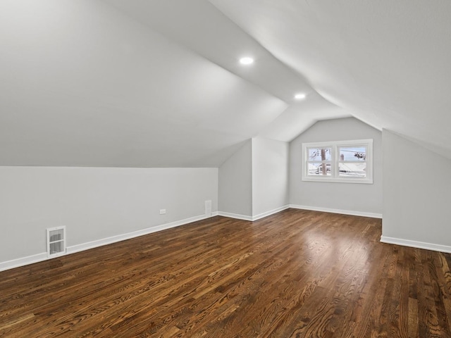 bonus room with dark hardwood / wood-style floors and vaulted ceiling