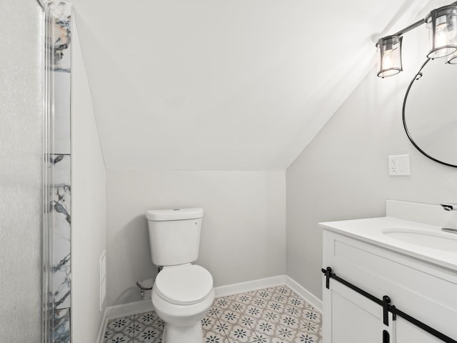 bathroom with vanity, vaulted ceiling, and toilet