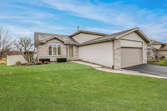 single story home with a garage and a front lawn