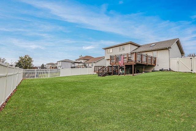 back of property featuring a yard and a wooden deck