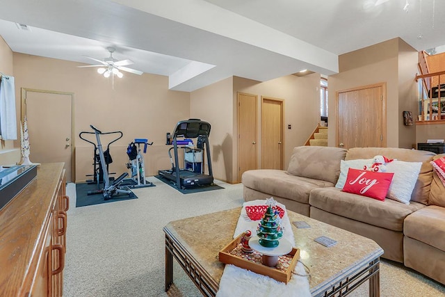 carpeted living room with ceiling fan