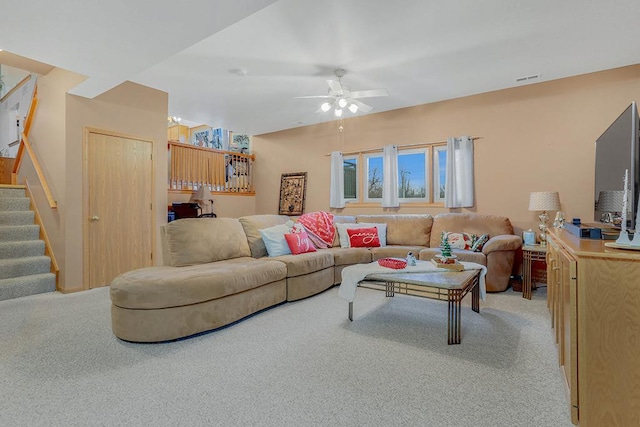 carpeted living room featuring ceiling fan