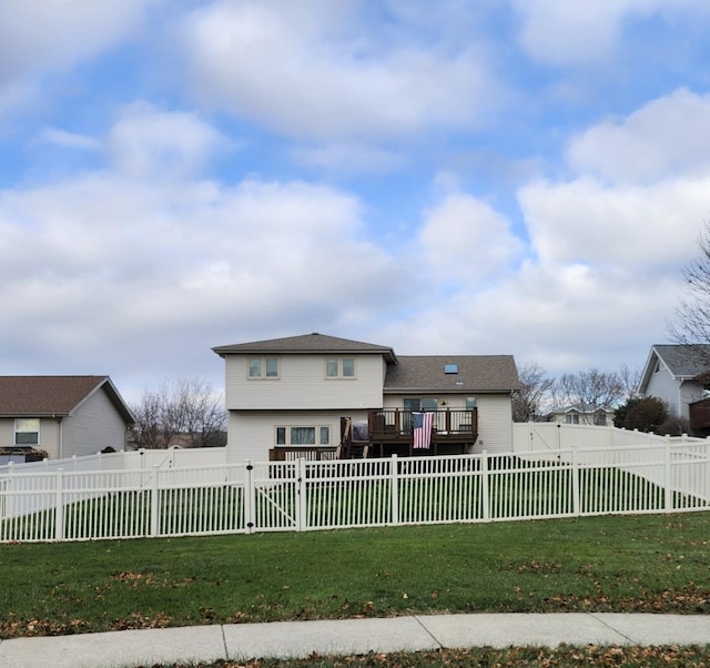 view of front of property with a front yard and a wooden deck