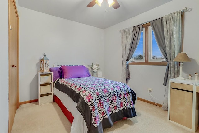 bedroom featuring ceiling fan and light carpet