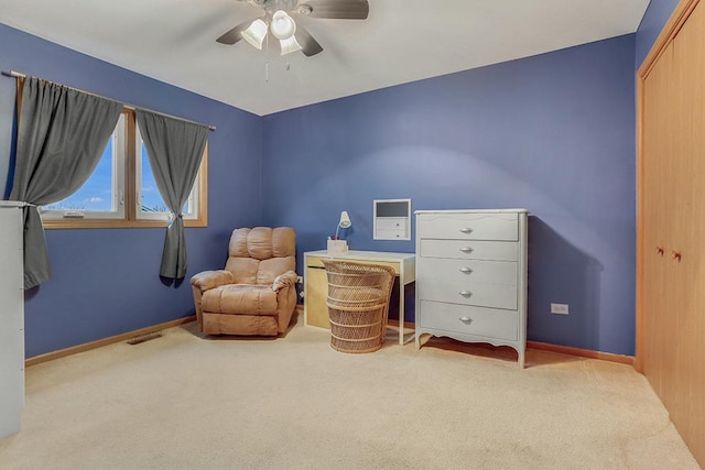 living area with light colored carpet and ceiling fan