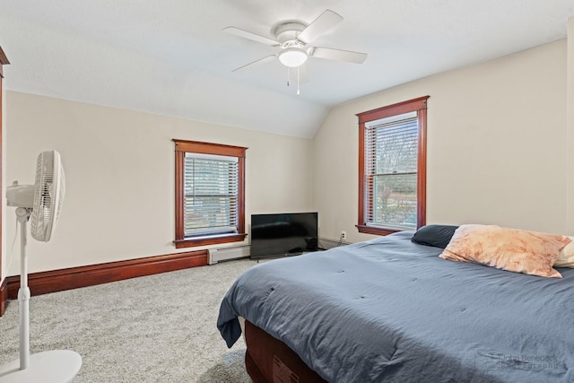 carpeted bedroom featuring ceiling fan, a baseboard radiator, and vaulted ceiling